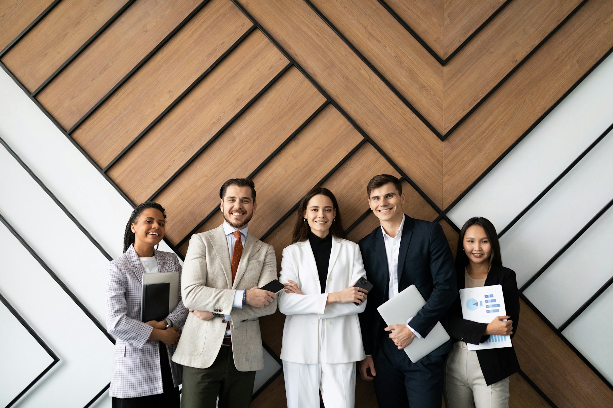 smiling young and old multiracial workers staff group pose together as human resource