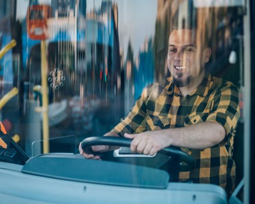 Bus driver behind the wheel of a public transport vehicle