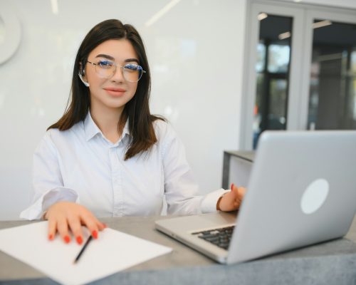 Young female receptionist working in office